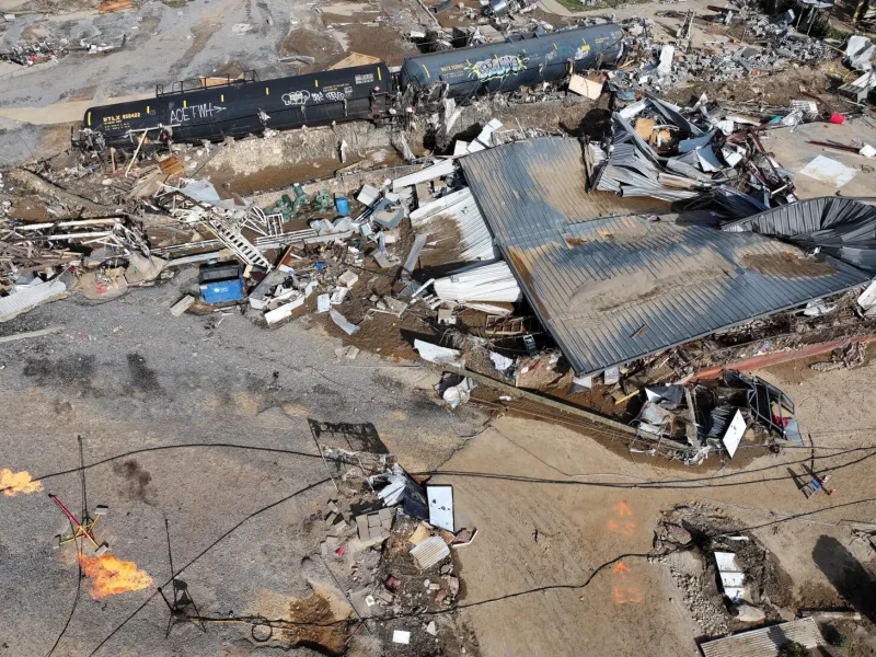 ASHEVILLE, NORTH CAROLINA - OCTOBER 04: An aerial view of gas being burned off near overturned tank cars amid flood damage wrought by Hurricane Helene along the Swannanoa River on October 4, 2024 in Asheville, North Carolina. At least 215 people were killed in six states in the wake of the powerful hurricane which made landfall as a Category 4. President Joe Biden ordered the deployment of 1,000 active duty U.S. soldiers to assist with storm relief efforts in what is now the deadliest U.S. mainland hurricane since Hurricane Katrina.  (Photo by Mario Tama/Getty Images)